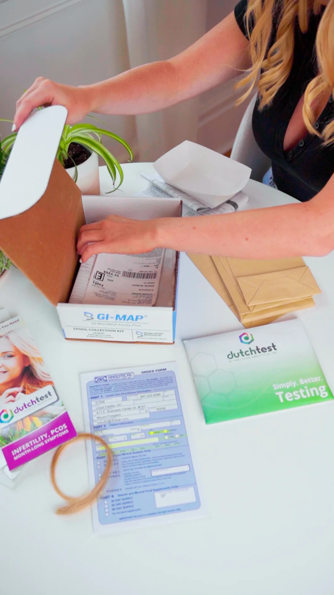 Our skin-focused nutritionist opening the GI map stool test kit