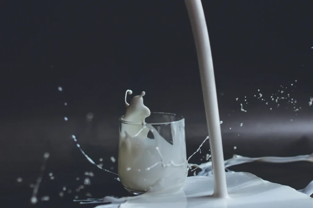 Milk pouring down and splashing everywhere