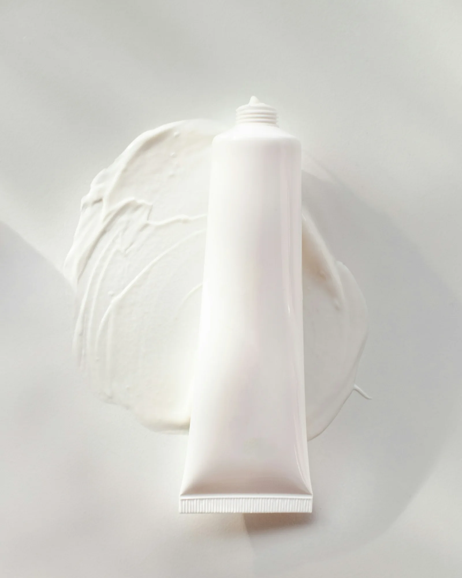 Cream smeared underneath tube of product 