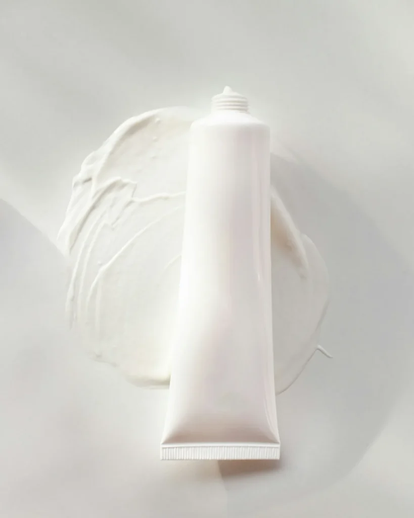 Cream smeared underneath tube of product